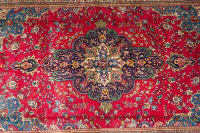 A Persian Mashad rug with central medallion and floral design, wool on cotton, 20th C.