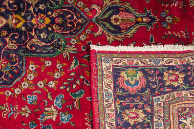 A Persian Mashad rug with central medallion and floral design, wool on cotton, 20th C.