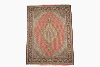 A Persian Tabriz rug with central medallion and floral design, wool on cotton, first half 20th C.