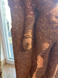 A large Indian red sandstone stupa pillar with a devata shown as a woman and lotus flowers, probably Matura region, ca. 2nd C. b.C - 2nd C.