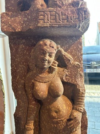 A large Indian red sandstone stupa pillar with a devata shown as a woman and lotus flowers, probably Matura region, ca. 2nd C. b.C - 2nd C.