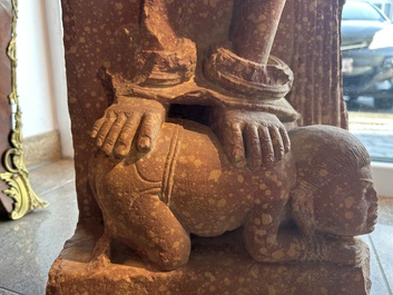 A large Indian red sandstone stupa pillar with a devata shown as a woman and lotus flowers, probably Matura region, ca. 2nd C. b.C - 2nd C.