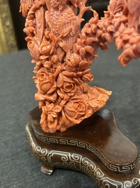 A Chinese red coral group of parrots among blossoming branches on a silver-inlaid wooden stand, 19th/20th C.