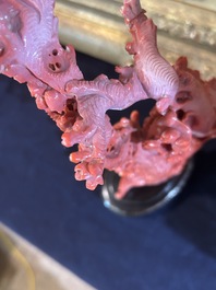 A Chinese red coral group of birds among blossoming branches on a silver-inlaid wooden stand, 19th/20th C.