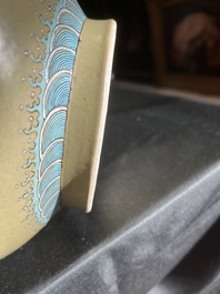 A Chinese famille rose enamelled teadust-glazed bottle vase with dragons, Qianlong mark, 19th C.