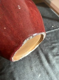 A Chinese monochrome oxblood-glazed bottle vase and a jar and cover, 19th C.
