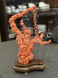 A Chinese red coral group of parrots among blossoming branches on a silver-inlaid wooden stand, 19th/20th C.