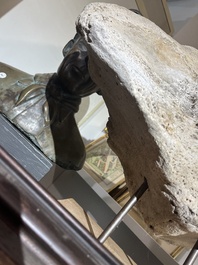 A large whale vertebra mounted on a wooden base, s.d.