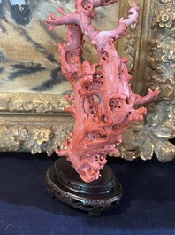A Chinese red coral group of birds among blossoming branches on a silver-inlaid wooden stand, 19th/20th C.