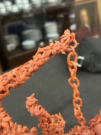 A Chinese red coral group of parrots among blossoming branches on a silver-inlaid wooden stand, 19th/20th C.