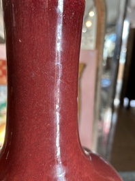 A Chinese monochrome oxblood-glazed bottle vase and a jar and cover, 19th C.