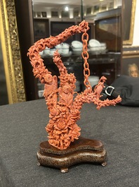 A Chinese red coral group of parrots among blossoming branches on a silver-inlaid wooden stand, 19th/20th C.