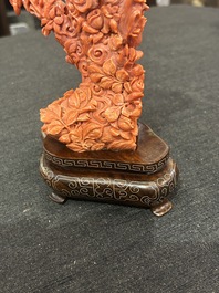 A Chinese red coral group of parrots among blossoming branches on a silver-inlaid wooden stand, 19th/20th C.