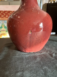 A Chinese monochrome oxblood-glazed bottle vase and a jar and cover, 19th C.