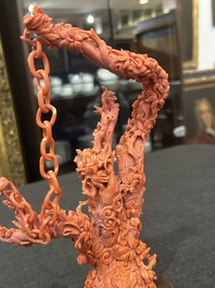 A Chinese red coral group of parrots among blossoming branches on a silver-inlaid wooden stand, 19th/20th C.