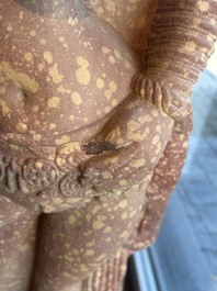 A large Indian red sandstone stupa pillar with a devata shown as a woman and lotus flowers, probably Matura region, ca. 2nd C. b.C - 2nd C.