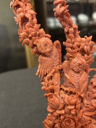 A Chinese red coral group of parrots among blossoming branches on a silver-inlaid wooden stand, 19th/20th C.