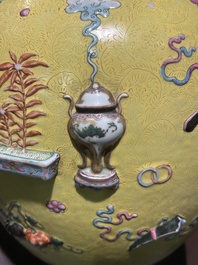 An exceptional pair of Chinese famille rose yellow sgraffito-ground bottle vases with applied design of antiquities, 19th C.