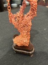 A Chinese red coral group of parrots among blossoming branches on a silver-inlaid wooden stand, 19th/20th C.