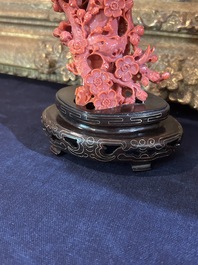 A Chinese red coral group of birds among blossoming branches on a silver-inlaid wooden stand, 19th/20th C.