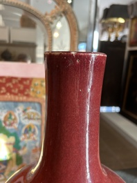 A Chinese monochrome oxblood-glazed bottle vase and a jar and cover, 19th C.