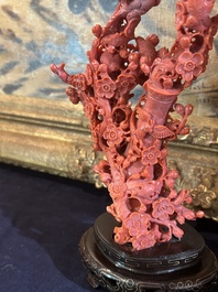 A Chinese red coral group of birds among blossoming branches on a silver-inlaid wooden stand, 19th/20th C.