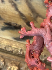 A Chinese red coral group of birds among blossoming branches on a silver-inlaid wooden stand, 19th/20th C.