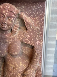 A large Indian red sandstone stupa pillar with a devata shown as a woman and lotus flowers, probably Matura region, ca. 2nd C. b.C - 2nd C.