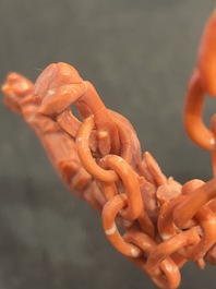 A Chinese red coral group of parrots among blossoming branches on a silver-inlaid wooden stand, 19th/20th C.