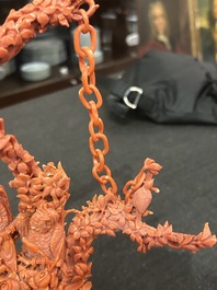 A Chinese red coral group of parrots among blossoming branches on a silver-inlaid wooden stand, 19th/20th C.