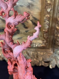A Chinese red coral group of birds among blossoming branches on a silver-inlaid wooden stand, 19th/20th C.