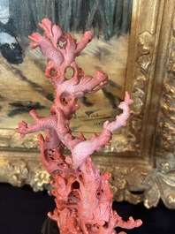 A Chinese red coral group of birds among blossoming branches on a silver-inlaid wooden stand, 19th/20th C.