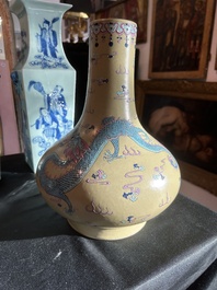 A Chinese famille rose enamelled teadust-glazed bottle vase with dragons, Qianlong mark, 19th C.