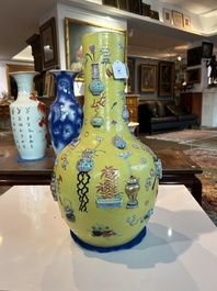 An exceptional pair of Chinese famille rose yellow sgraffito-ground bottle vases with applied design of antiquities, 19th C.
