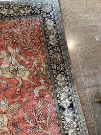 A Persian Qom (Qum/Ghom) silk rug with hunting scenes, 20th C.