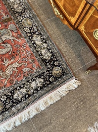 A Persian Qom (Qum/Ghom) silk rug with hunting scenes, 20th C.