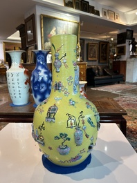 An exceptional pair of Chinese famille rose yellow sgraffito-ground bottle vases with applied design of antiquities, 19th C.