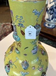 An exceptional pair of Chinese famille rose yellow sgraffito-ground bottle vases with applied design of antiquities, 19th C.