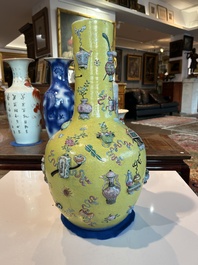 An exceptional pair of Chinese famille rose yellow sgraffito-ground bottle vases with applied design of antiquities, 19th C.