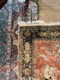 A Persian Qom (Qum/Ghom) silk rug with hunting scenes, 20th C.