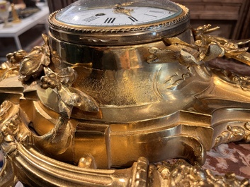 A French gilt bronze Louis XVI style cartel clock with floral design, late 19th C.