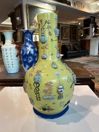 An exceptional pair of Chinese famille rose yellow sgraffito-ground bottle vases with applied design of antiquities, 19th C.