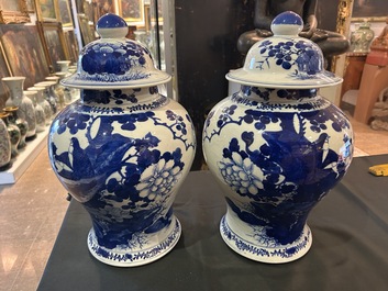 A pair of Chinese blue and white vases and covers with magpies among peonies, 19th C.