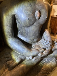 An Indian polished black marble sculpture of a Jina seated in dhyanasana on an ornate cushion, probably Gujarat, 15th C.