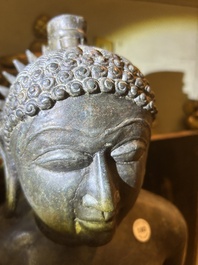 An Indian polished black marble sculpture of a Jina seated in dhyanasana on an ornate cushion, probably Gujarat, 15th C.