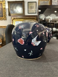 A pair of Chinese blue ground jars with enamelled decoration of butterflies and flowers, 19th C.