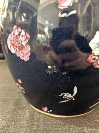 A pair of Chinese blue ground jars with enamelled decoration of butterflies and flowers, 19th C.