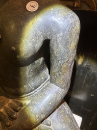 An Indian polished black marble sculpture of a Jina seated in dhyanasana on an ornate cushion, probably Gujarat, 15th C.