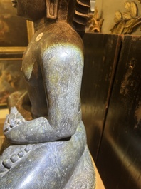 An Indian polished black marble sculpture of a Jina seated in dhyanasana on an ornate cushion, probably Gujarat, 15th C.