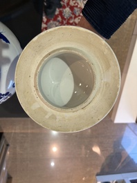 A pair of Chinese blue and white vases and covers with magpies among peonies, 19th C.